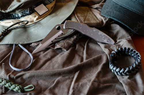 Folding pocket knife and paracord bracelet. Everyday knife set.Men's clothing style. Men's items. photo