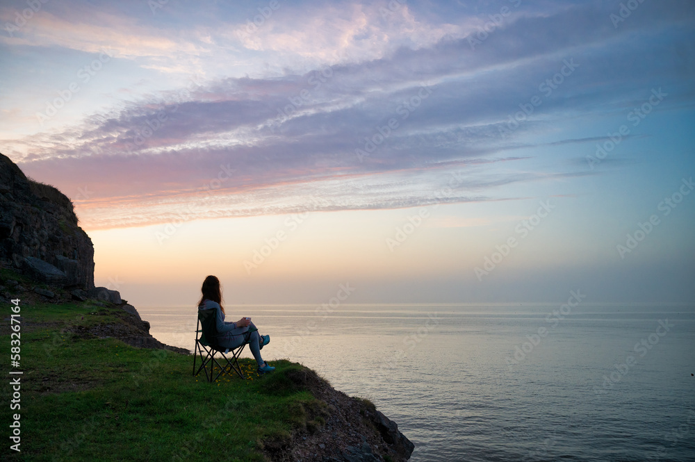 silhouette of a person on a rock