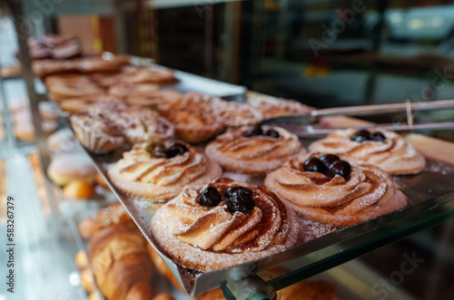 Fresh pastries behind the glass of a cafe on the street.