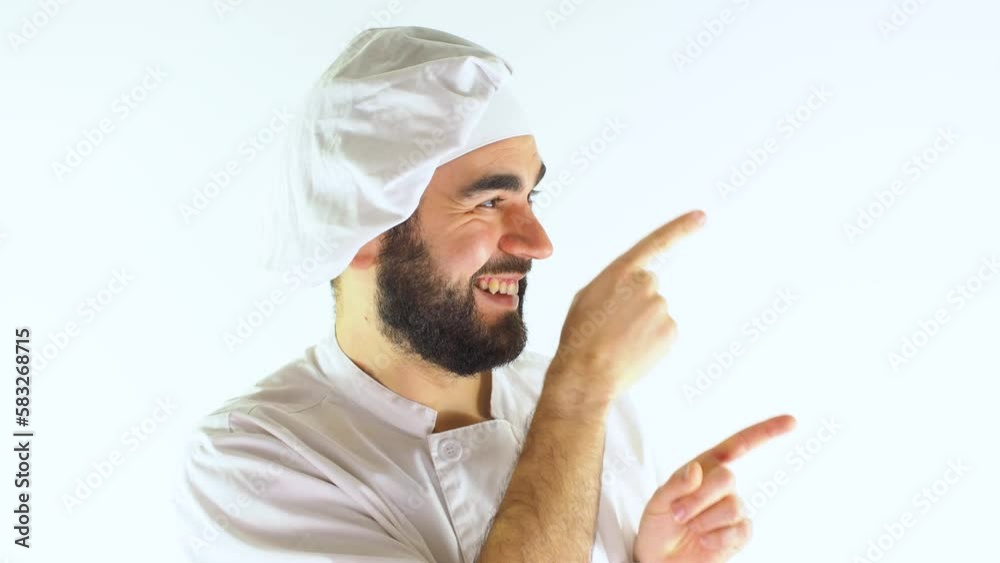 Young male chef pointing right with both hands while smiling and looking at camera. Isolated on a white background Young male chef pointing right with both hands while smiling and looking at camera. Isolated on a white background
