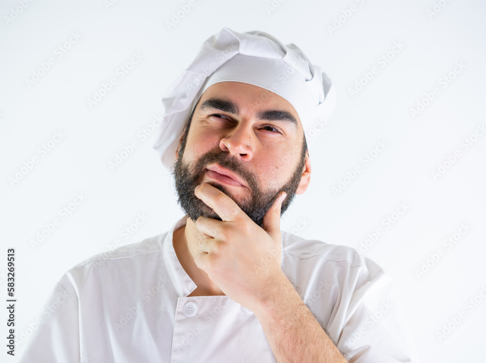 Young male chef thinking. Isolated on a white background Young male chef thinking. Isolated on a white background