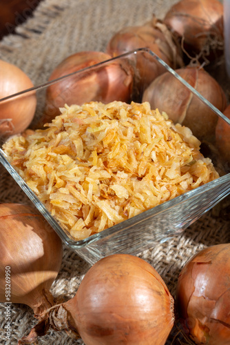 Dried yellow frakes of onion, asian cuisine, close up photo