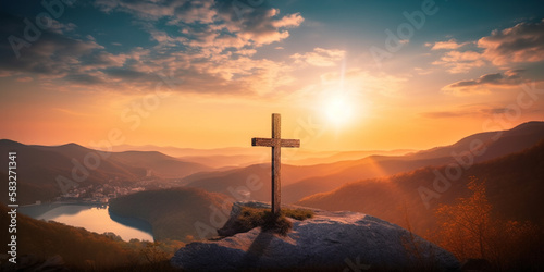 cross in the mountains at sunset