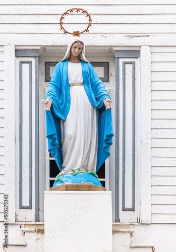 Konstfotografi Fairbanks, Alaska, USA - July 27, 2011: Closeup, Virgin Mary statue above entrance to historic white wooden Immaculate Conception Catholic church