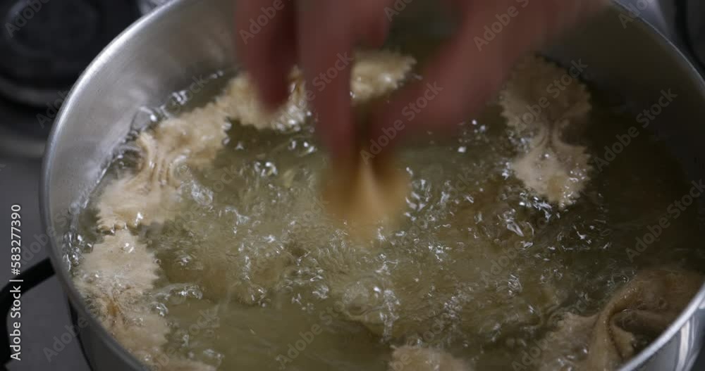 Golden treasures in the making: observe chebakia frying to perfection, releasing enticing aromas in the kitchen. Golden treasures in the making: observe chebakia frying to perfection, releasing enticing aromas in the kitchen.