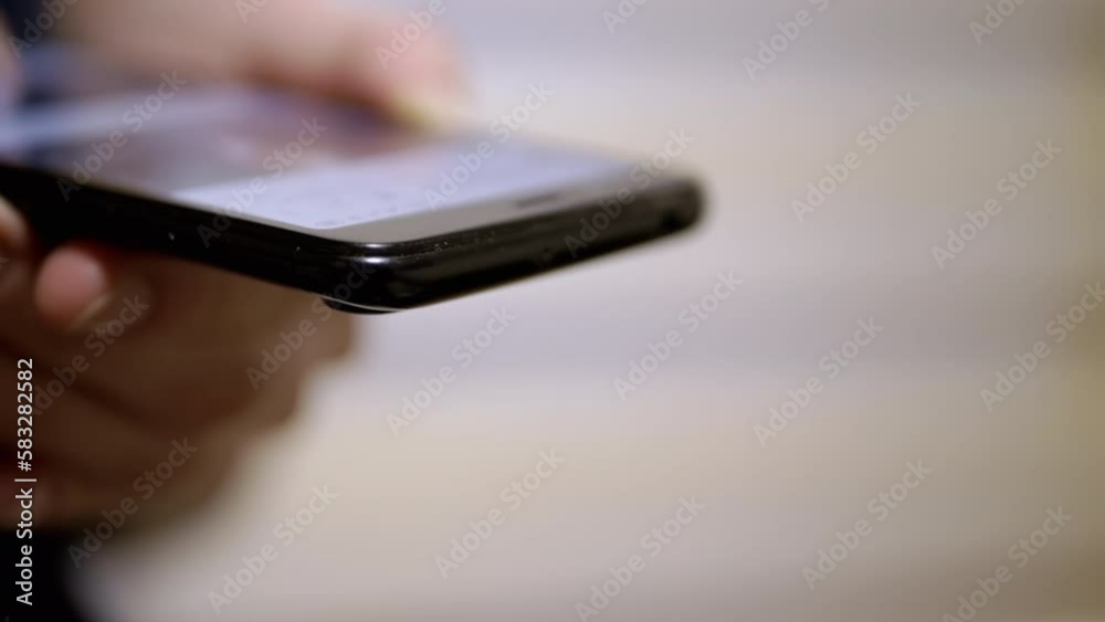 Female Fingers Scroll through the News Feed in Social Networks on a Mobile Phone. Close-up. Woman quickly browsing mobile applications on a smartphone. Fingers touch the screen. Life in a smartphone. Female Fingers Scroll through the News Feed in Social Networks on a Mobile Phone. Close-up. Woman quickly browsing mobile applications on a smartphone. Fingers touch the screen. Life in a smartphone.