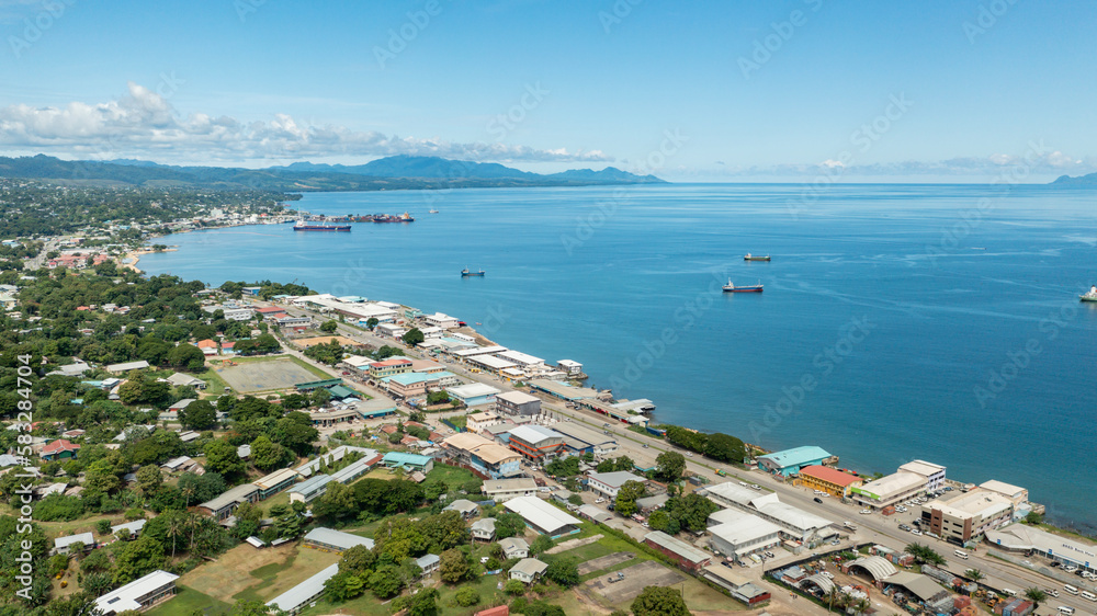 Coastal view of the main road and seaside shops in Honiara.
