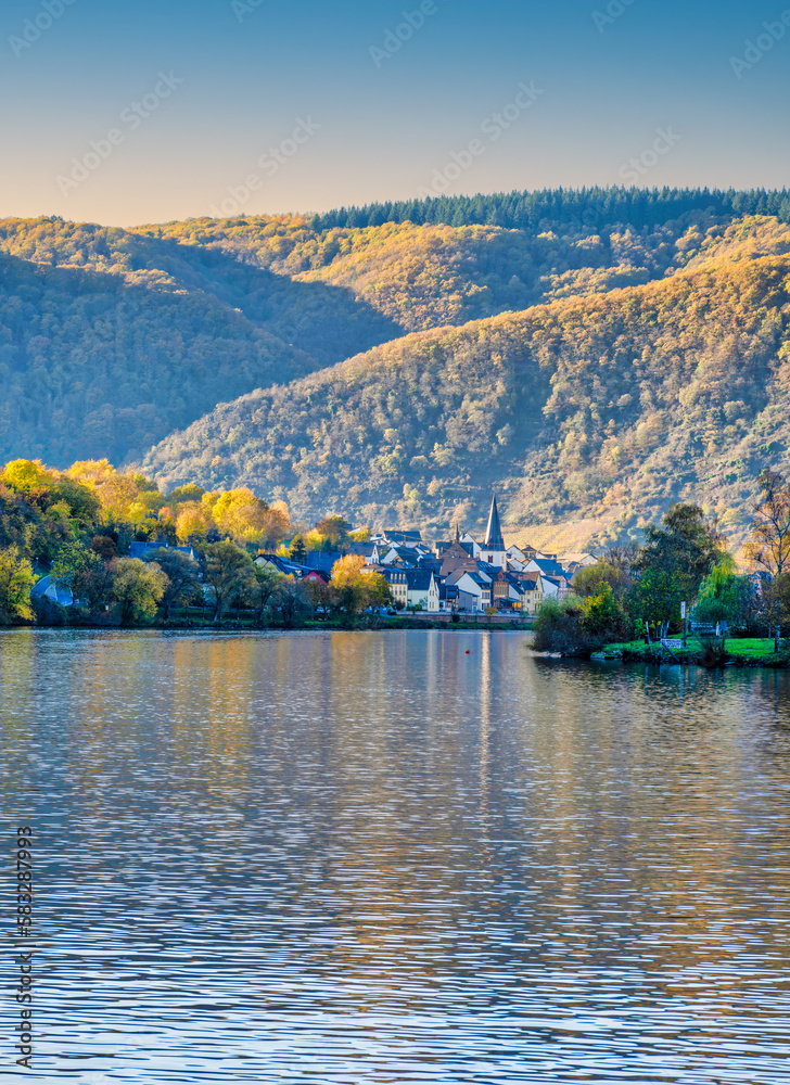 Briedern village nestled in the mountains on Moselle river during a beautiful autumn day in Cochem-Zell, Germany