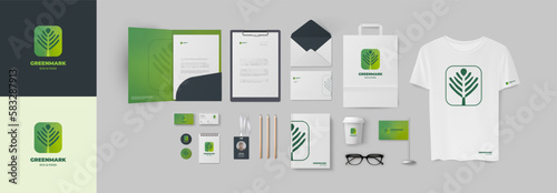 Starter pack for company design include green plant logo in minimalistic style and corporate identity set. Folder A4 and business card, envelope and ID badge, notepad and t-shirt, letterhead and cup