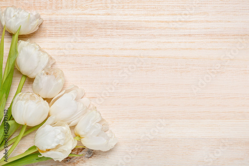Beautiful tulip flowers on wooden background. Mother's Day celebration © Pixel-Shot