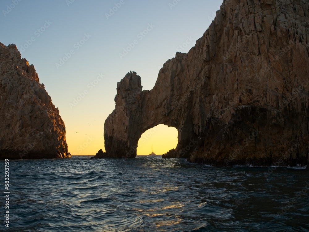 The sun sets on the Pacific side of Cabo San Lucas, with the glow making almost a silhouette out of the Arch of Cabo San Lucas