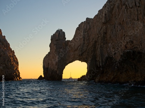 The sun sets on the Pacific side of Cabo San Lucas  with the glow making almost a silhouette out of the Arch of Cabo San Lucas