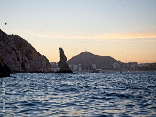 Looking back towards Cabo San Lucas, featuring a rock formation jutting out of the water that, if turned upside down, would resemble the shape of the peninsula of Baja California.