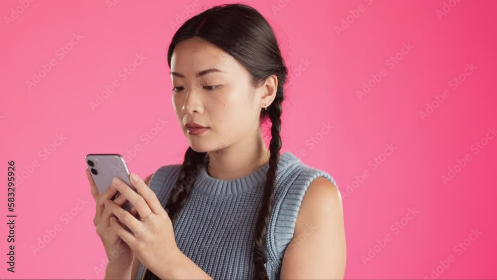 Serious, phone and text message with asian woman in studio for connection, concentration and typing. Browsing, news and app with girl and reading online for satisfaction, website and technology Serious, phone and text message with asian woman in studio for connection, concentration and typing. Browsing, news and app with girl and reading online for satisfaction, website and technology