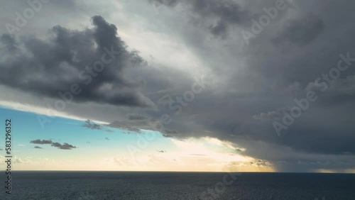 4K Aerial view. Blue sky sun and fog over calm sea. The drone flies over foggy and fluffy clouds. photo