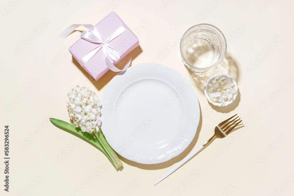 Clean plate, gift box and beautiful hyacinth flower on beige background Clean plate, gift box and beautiful hyacinth flower on beige background