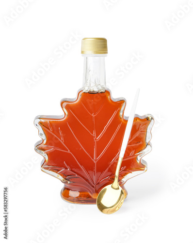 Bottle and spoon of tasty maple syrup on white background