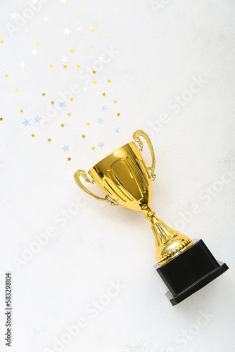 Gold cup with stars on white background