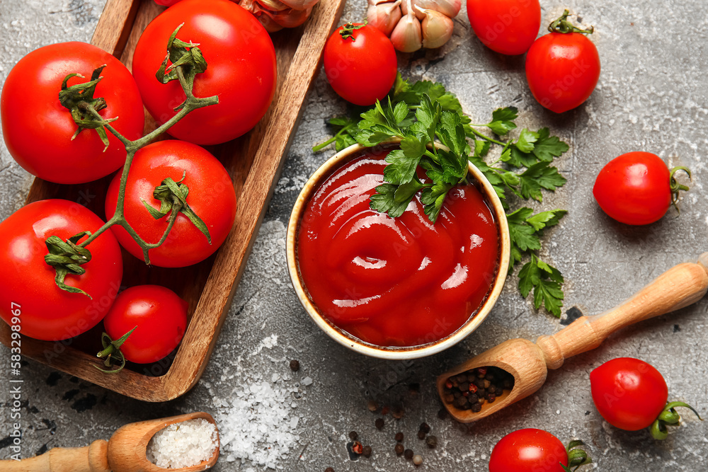 Bowl with tasty ketchup and fresh vegetables on grunge background Bowl with tasty ketchup and fresh vegetables on grunge background