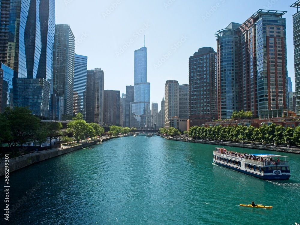 High rises loom above the Chicago River, forming a man-made canyon of buildings
