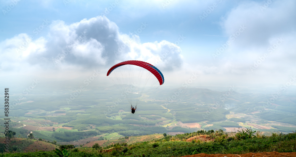 Paragliding on Chu Tan Kra mountain peak in Sa Thay district, Kon Tum province, Vietnam Paragliding on Chu Tan Kra mountain peak in Sa Thay district, Kon Tum province, Vietnam