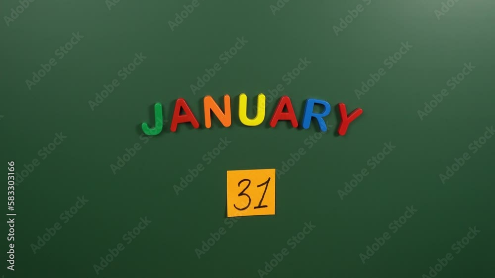 Hand sticking a sticker 31 January calendar day on school board. 31 date of January. Thirty first day of January. 31th date number. 31 day calendar. Thirty one date Hand sticking a sticker 31 January calendar day on school board. 31 date of January. Thirty first day of January. 31th date number. 31 day calendar. Thirty one date
