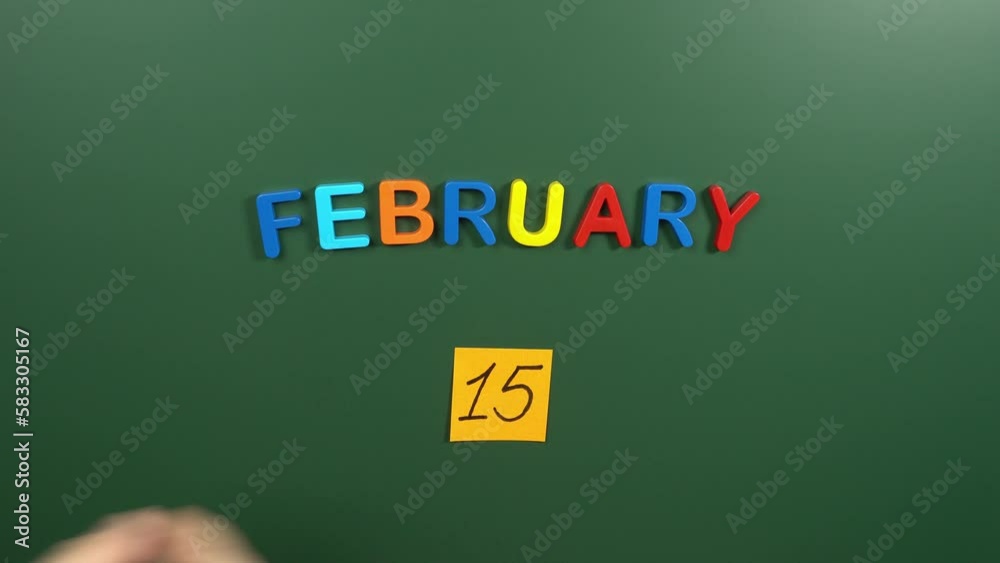 Hand sticking a sticker 15 February calendar day on school board. 15 date of February. Fifteenth day of February. 15th date number. 15 day calendar. Fifteen date Hand sticking a sticker 15 February calendar day on school board. 15 date of February. Fifteenth day of February. 15th date number. 15 day calendar. Fifteen date