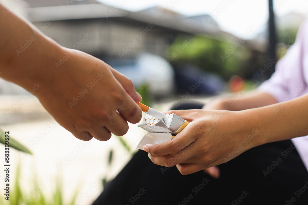 Close up of hand is taking cigarette from cigarette pack, accepting an offer.