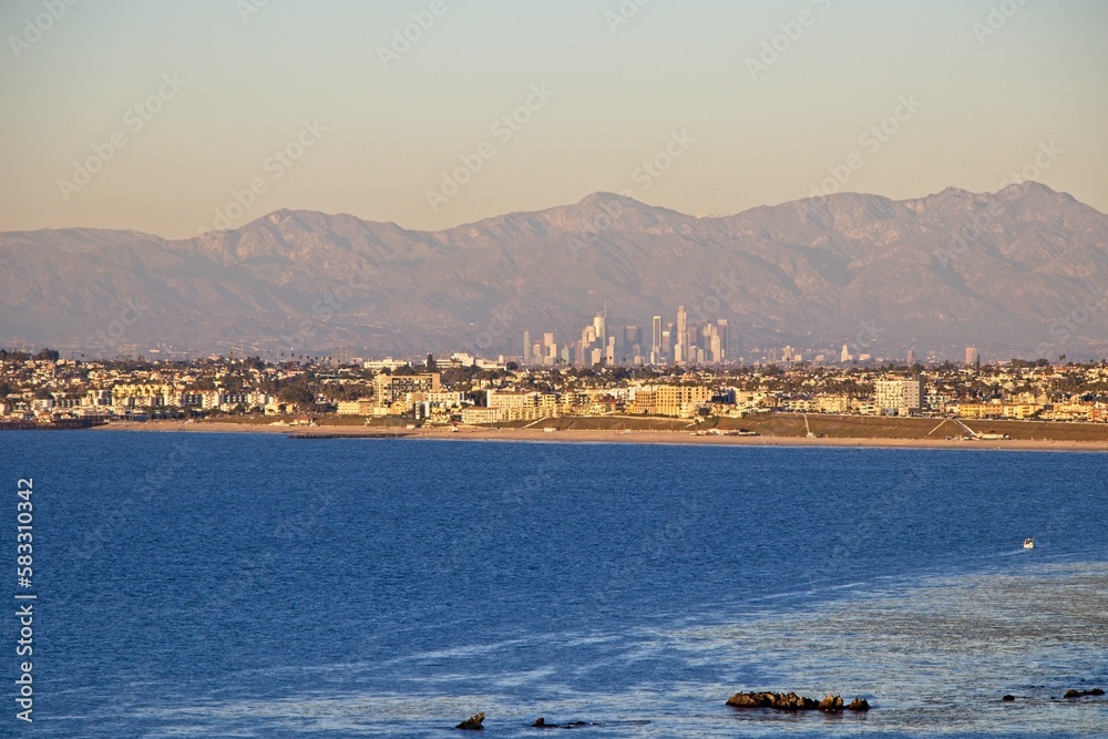 On a particularly clear day, the skyline of Los Angeles, with the towering San Gabriel Mountains in the background, can be seen across Santa Monica Bay from the Palos Verdes Peninsula