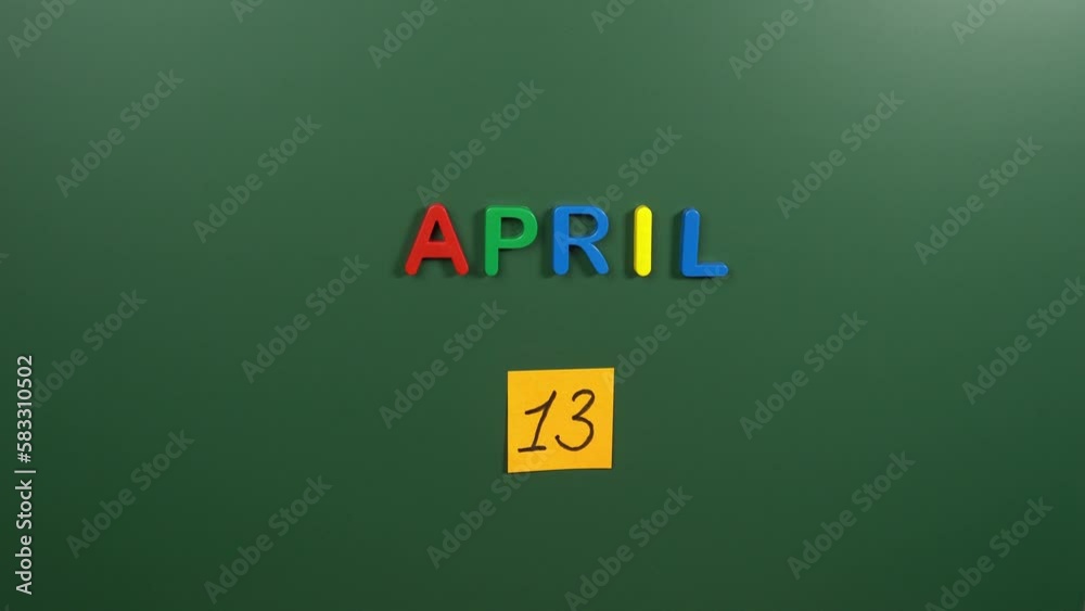 Hand sticking a sticker 13 April calendar day on school board. 13 date of April. Thirteenth day of April. 13th date number. 13 day calendar. Thirteen date Hand sticking a sticker 13 April calendar day on school board. 13 date of April. Thirteenth day of April. 13th date number. 13 day calendar. Thirteen date