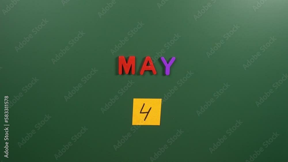 Hand sticking a sticker 4 May calendar day on school board. 4 date of May. Fourth day of May. 4th date number. 4 day calendar. Four date. 4th be with you Hand sticking a sticker 4 May calendar day on school board. 4 date of May. Fourth day of May. 4th date number. 4 day calendar. Four date. 4th be with you