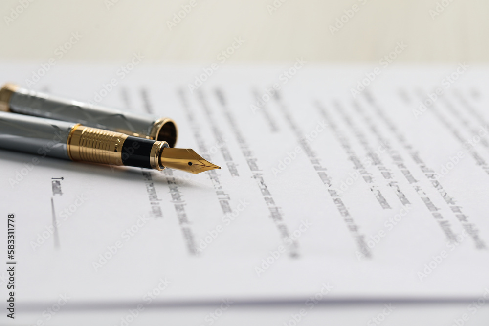 Fototapeta premium Fountain pen on paper document, closeup. Notary services