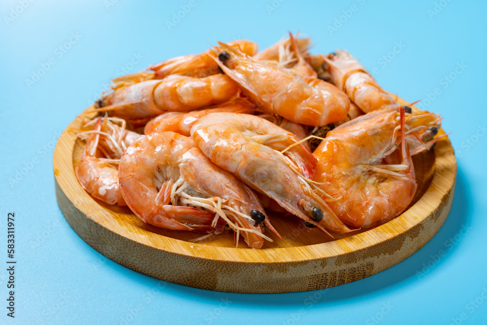 angle view fresh cooked shrimps on blue angle view fresh cooked shrimps on blue