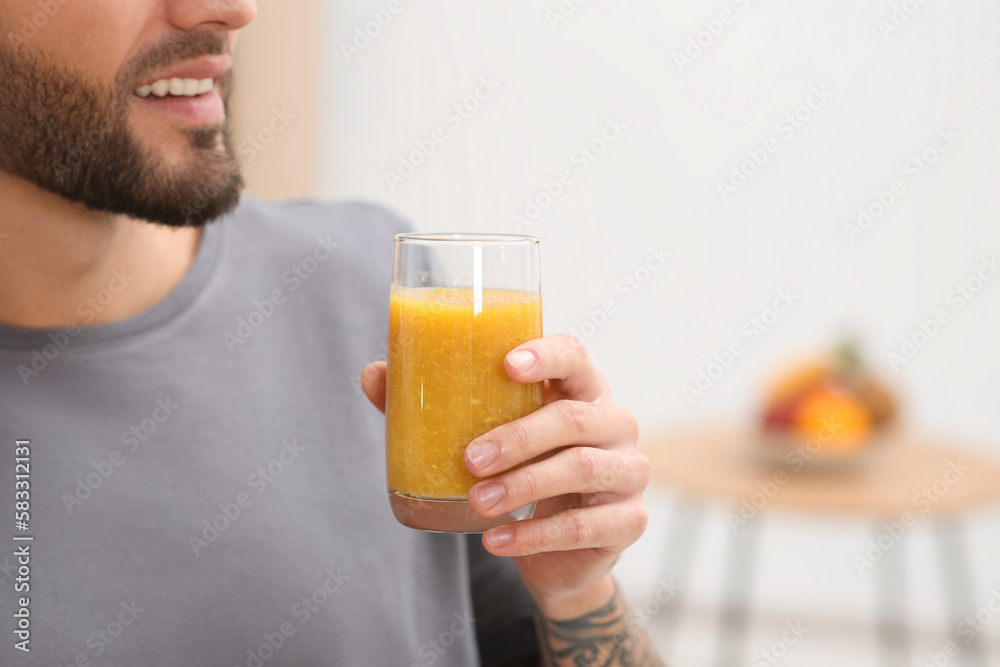 Man with delicious smoothie at home, closeup. Space for text Man with delicious smoothie at home, closeup. Space for text