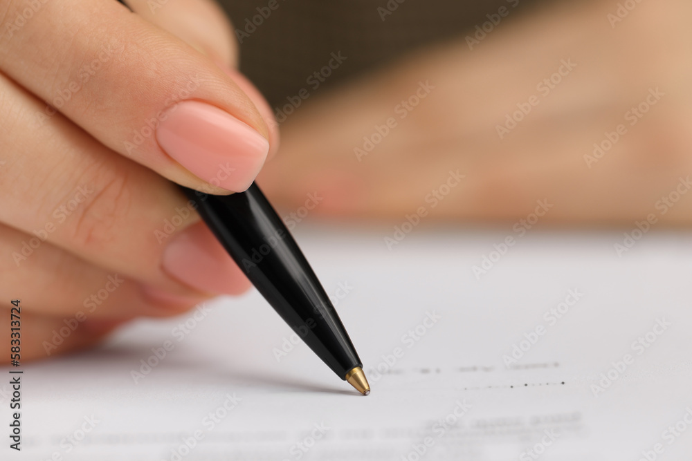 Woman signing document, closeup view. Space for text Woman signing document, closeup view. Space for text