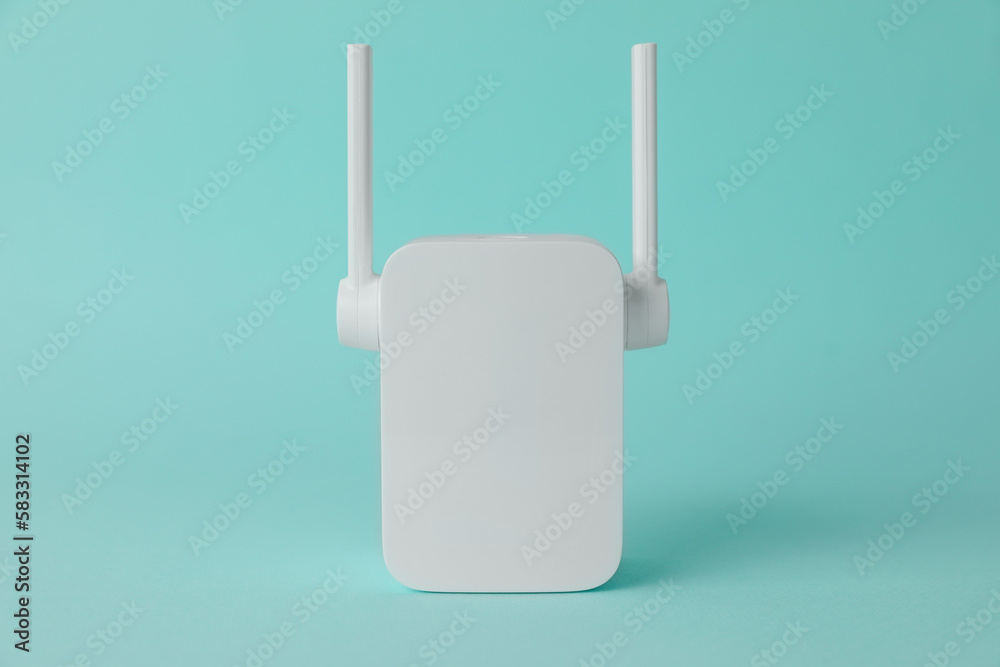 New modern Wi-Fi repeater on turquoise background New modern Wi-Fi repeater on turquoise background