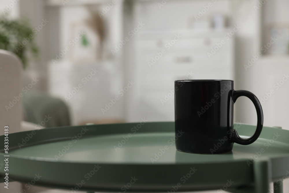 Blank ceramic mug on green table. Mockup for design Blank ceramic mug on green table. Mockup for design