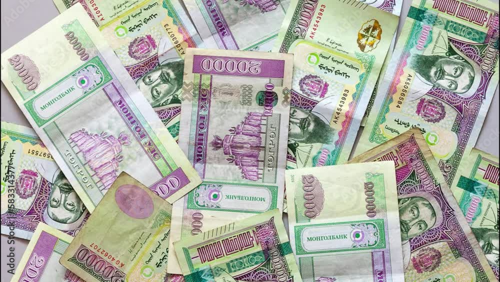 Flat lay of Mongolian paper money in denominations of 2000 tugriks. Mongol economy and finance. Currency background. Concept of business, banking. Top view, close-up Flat lay of Mongolian paper money in denominations of 2000 tugriks. Mongol economy and finance. Currency background. Concept of business, banking. Top view, close-up