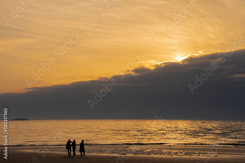 Family enjoying the sunset at the sea in Korea