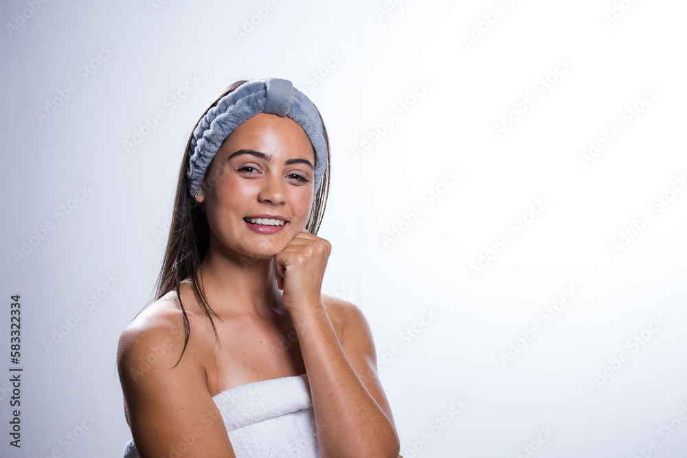 Glowing Beauty: Young Woman's Beauty Routine on White Background Glowing Beauty: Young Woman's Beauty Routine on White Background