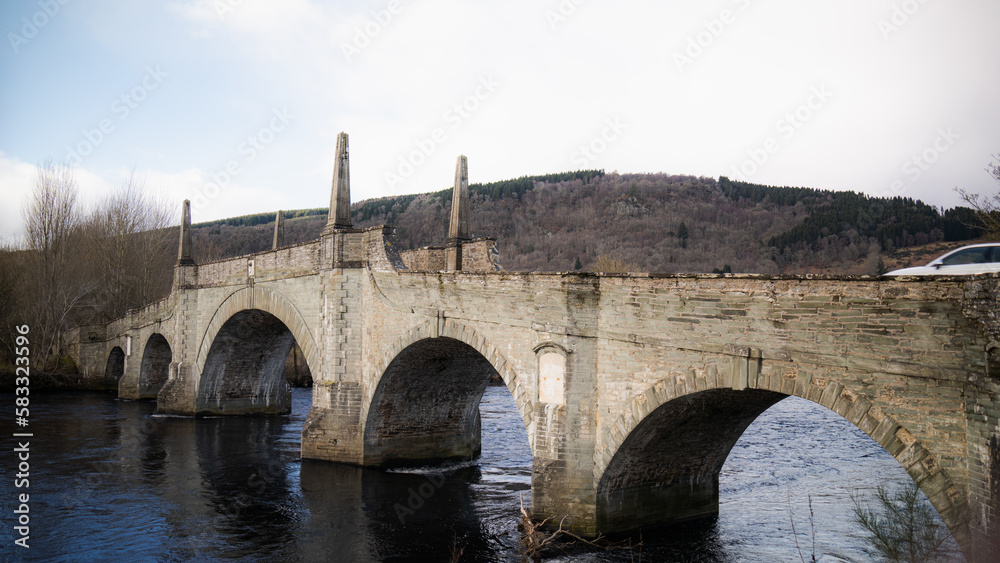 old historical stone bridge. Water flows under the bridge