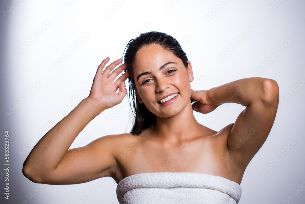 Fototapeta premium Glowing Beauty: Young Woman's Beauty Routine on White Background