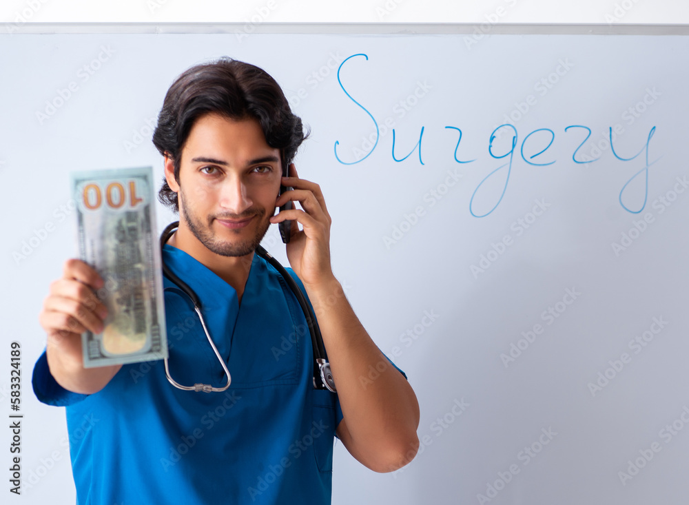 Young male doctor in front of whiteboard