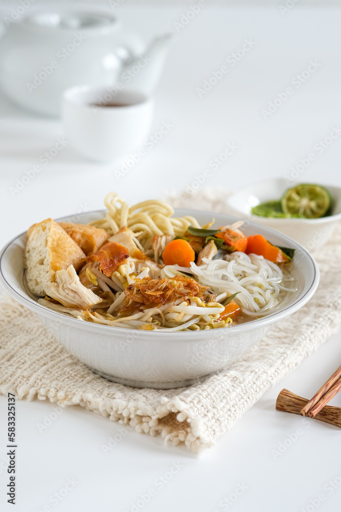 mie sop is a noodle and rice vermicelli in chicken soup with spices, topping shredded fried chicken, tofu and onion dan vegetables mie sop is a noodle and rice vermicelli in chicken soup with spices, topping shredded fried chicken, tofu and onion dan vegetables
