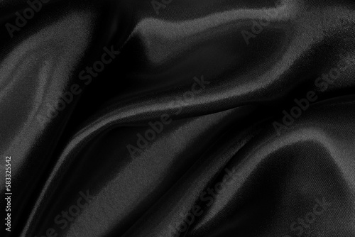 Black fabric cloth texture for background and design art work, beautiful crumpled pattern of silk or linen.