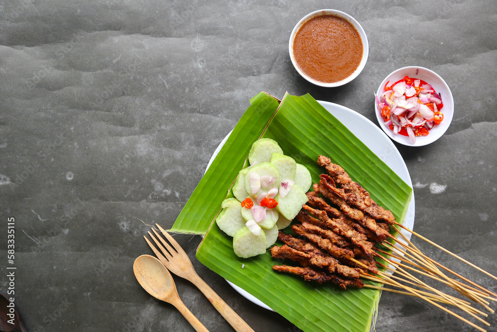 chicken satay or chicken satay served with lontong, rice cake and