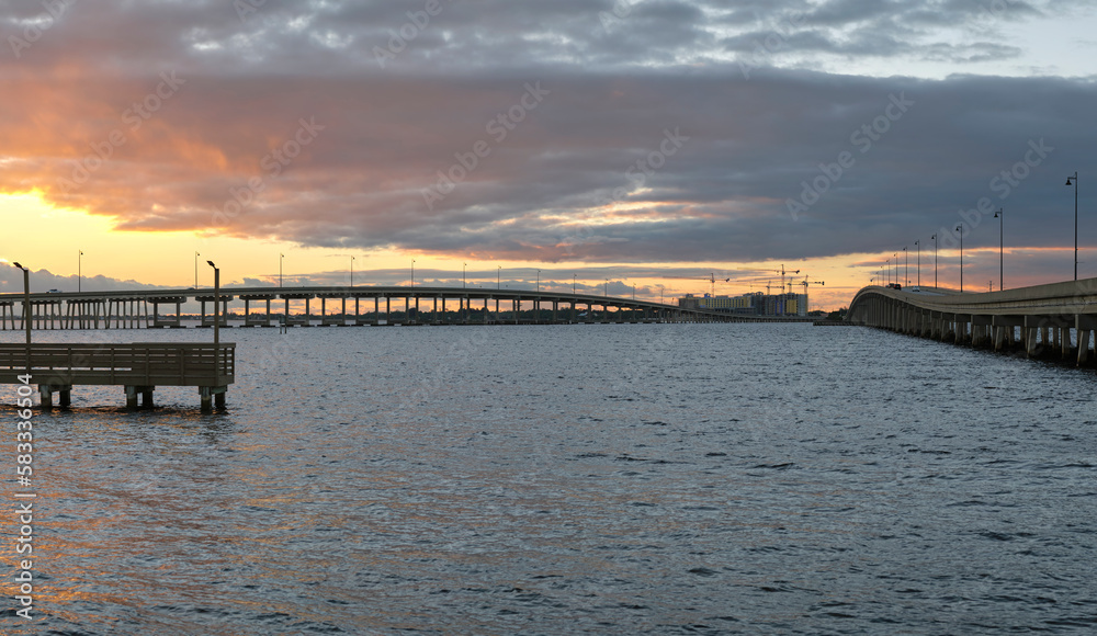 Barron Collier Bridge and Gilchrist Bridge in Florida with moving traffic. Transportation infrastructure in Charlotte County connecting Punta Gorda and Port Charlotte over Peace River