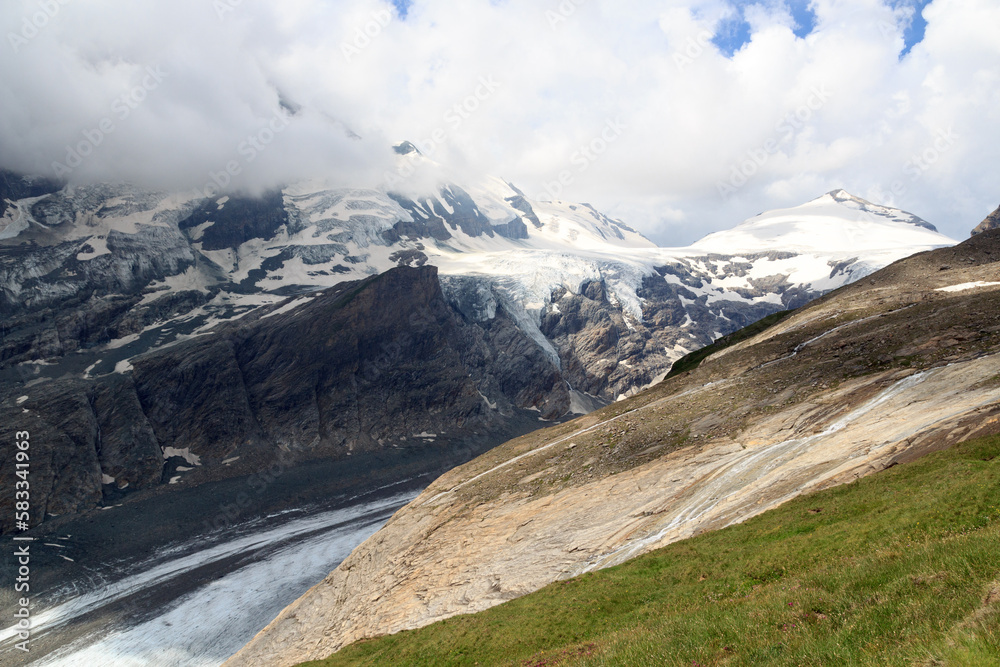 Mountain snow panorama with glacier Pasterze and clouds in High Tauern Alps, Austria