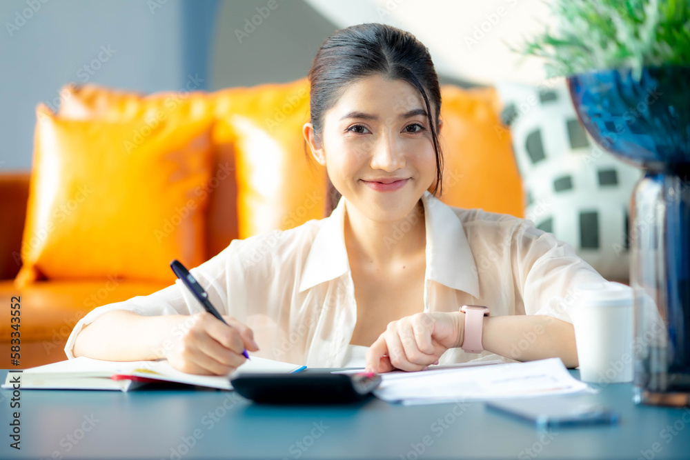 Attractive happy woman paying bills accounting costs charges taxes and credit card expenses using calculator looking pleased and happy in e-banking and home finance concept. Attractive happy woman paying bills accounting costs charges taxes and credit card expenses using calculator looking pleased and happy in e-banking and home finance concept.