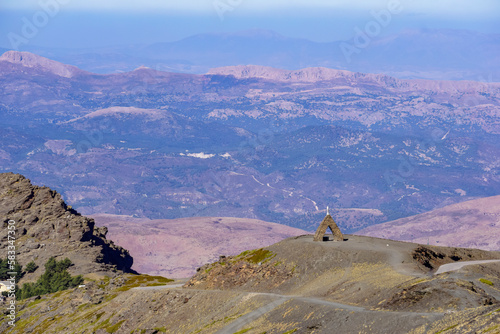 Landscape of the Alpujarras of Granada with the monument to the Virgen de las Nieves in the foreground and the mountains in the background